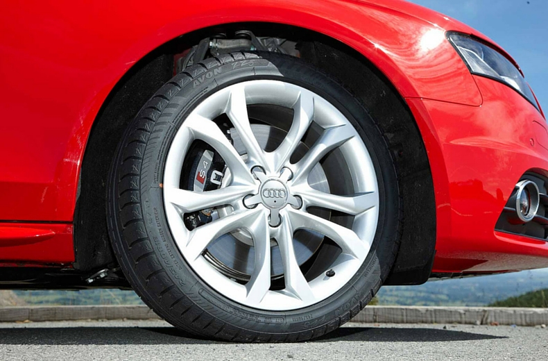 red audi car with sidewall tyre